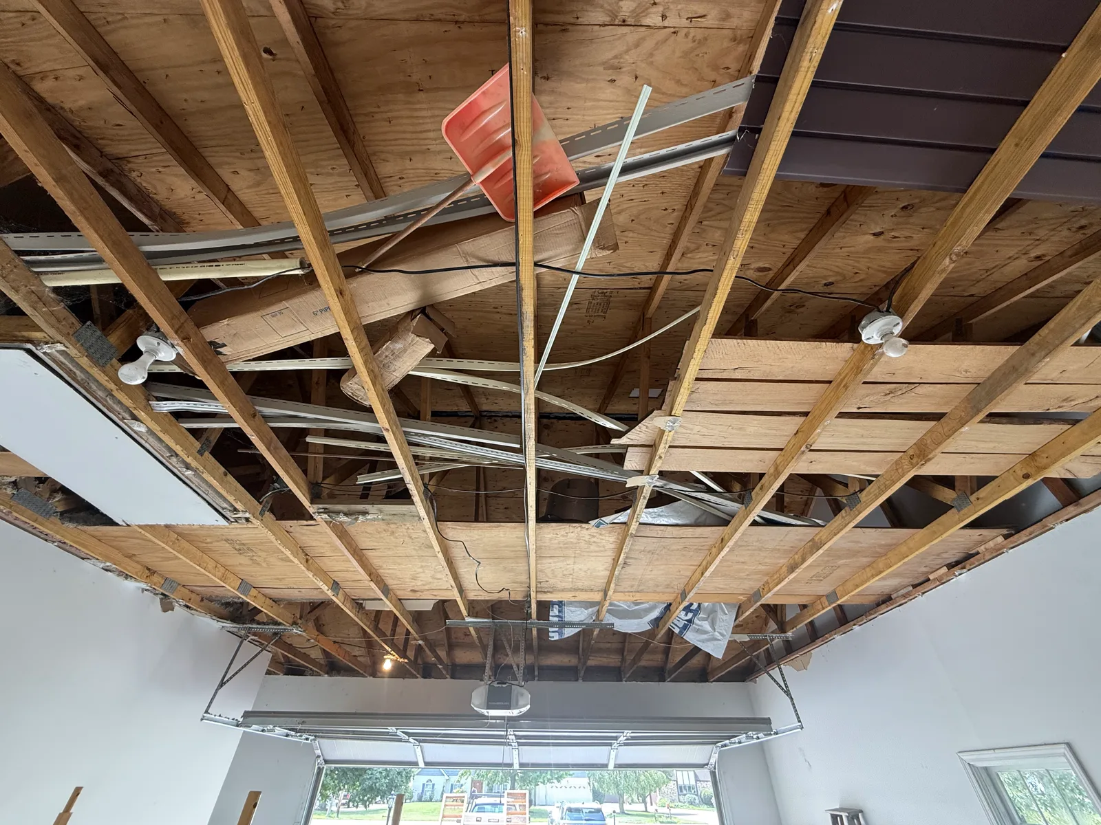 Stripped back to bare joists — wiring and ductwork exposed.