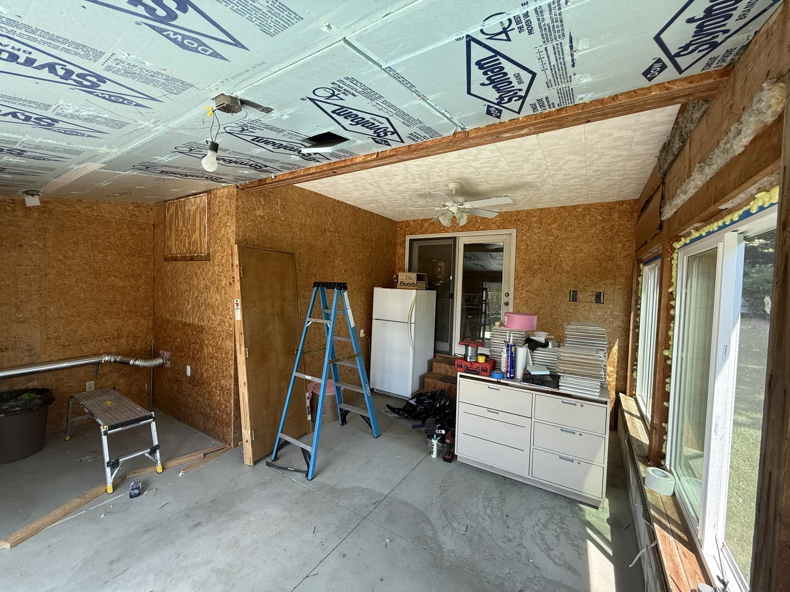 The original porch — dark wood paneling and a dated ceiling.