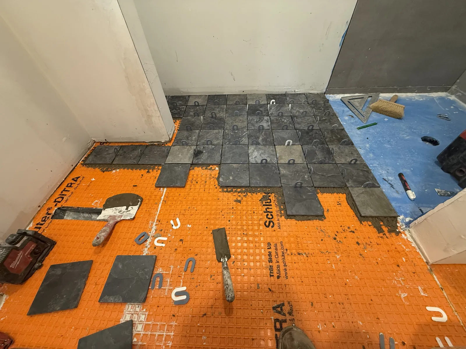 Wall tile being laid out and set.
